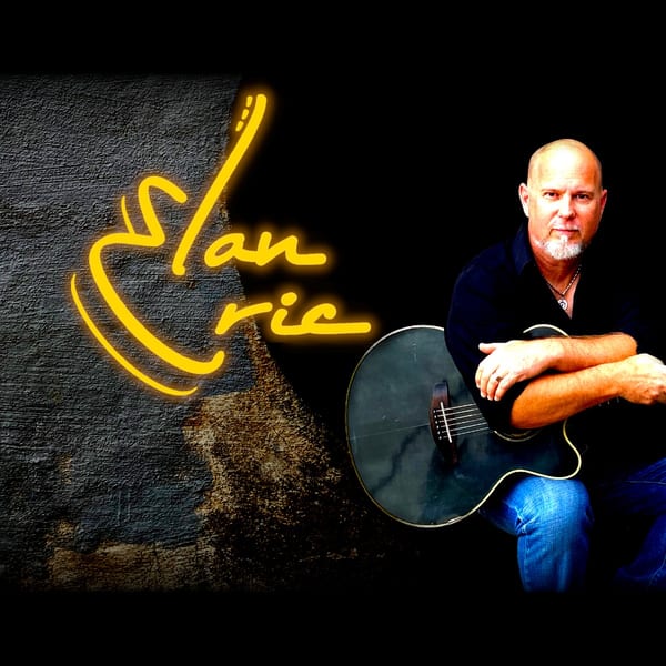 Musician Slan Eric with an acoustic guitar and glowing yellow logo.